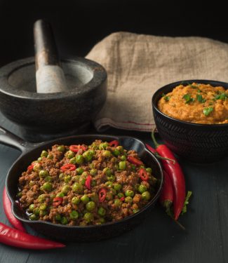indian restaurant keema matar in a small cast iron skillet