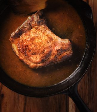 To make perfect pan fried pork chops, pick your chops wisely, use a heavy pan and finish the chop in the oven.