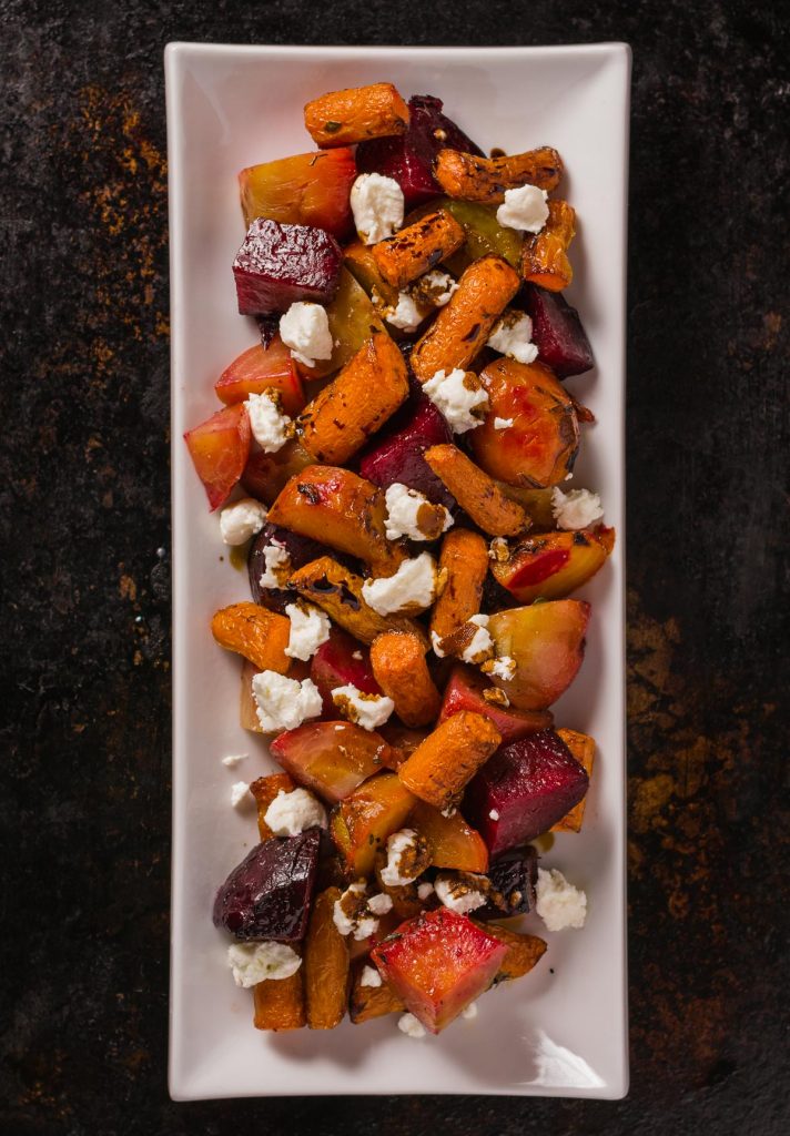 Roasted beets and carrots with goat cheese. This dish is brightened by a balsamic glaze to bring out the sweetness of the root vegetables.