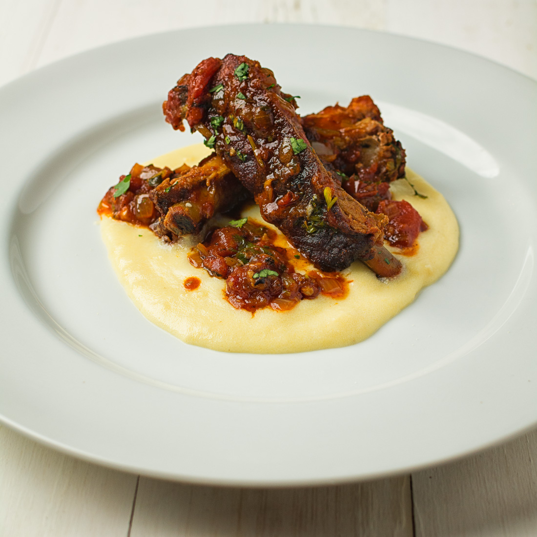Melting pork back ribs, fire roasted tomatoes and cheese polenta come together in this fine dining riff on Mexican pork chili.