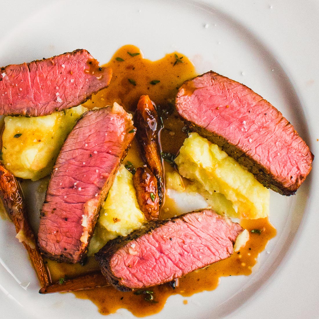 steak with thyme infused white wine sauce and truffled mashed