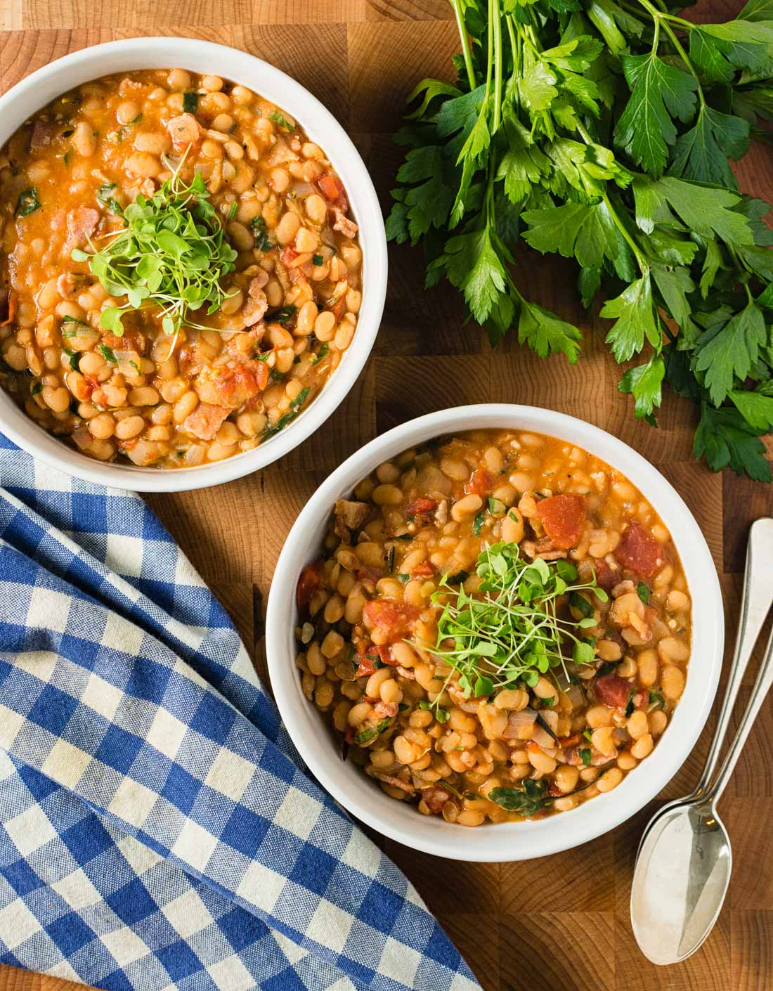 Rosemary, thyme, parsley, onion and garlic all come together in this warming and deeply satisfying savory navy bean stew.