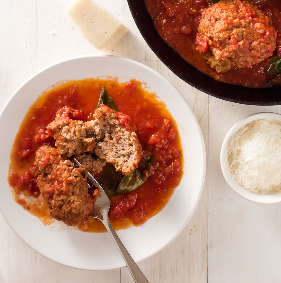 Rao's meatball with marinara on a small plate with fork.