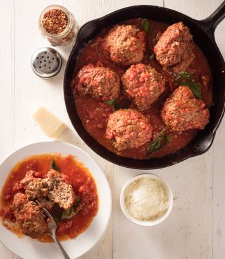 raos meatballs in marinara in a black cast iron frying pan