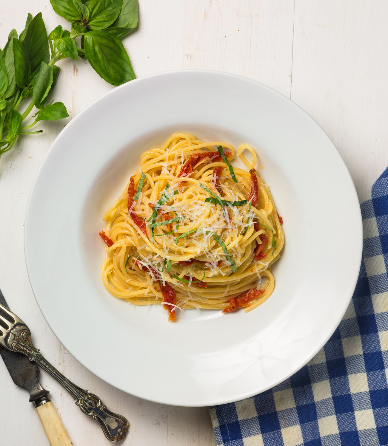 Spaghetti with sun-dried tomatoes and pecorino romano is a delicious weeknight meal.