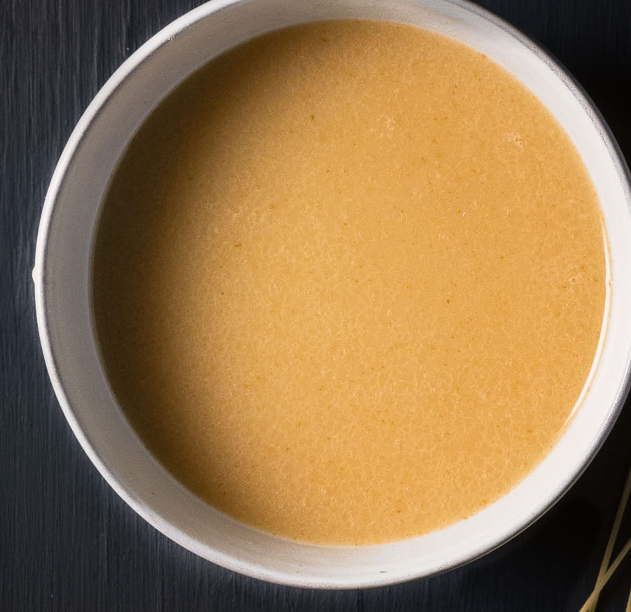 Tonkotsu ramen broth close-up from above.