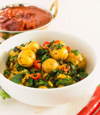 Sag aloo or spinach and potato curry is a delicious vegetarian meal.