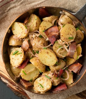 Warm potato salad with bacon makes a great side any time you grill.