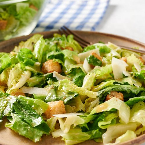 Close up of Caesar salad on a plate from the front.