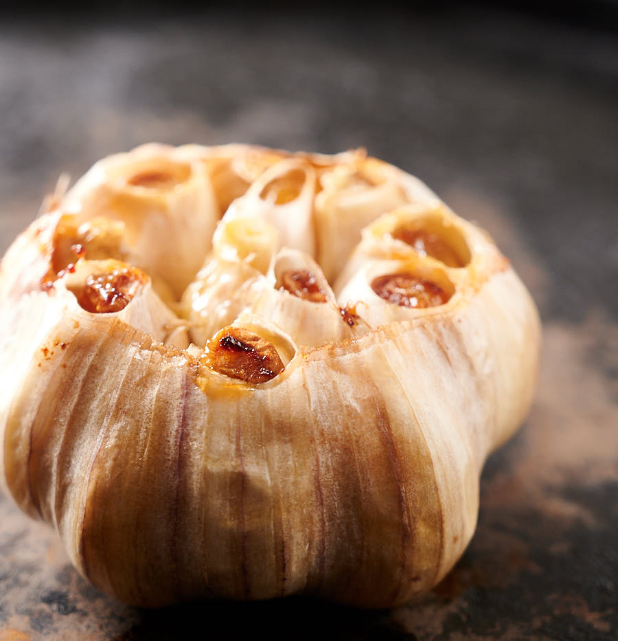 A head of roasted garlic from the front.