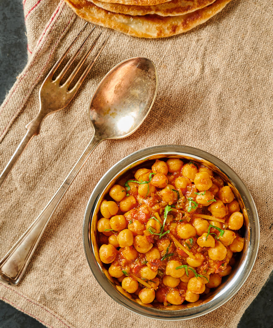 Easy chana masala in a bowl from above with spoon and fork.