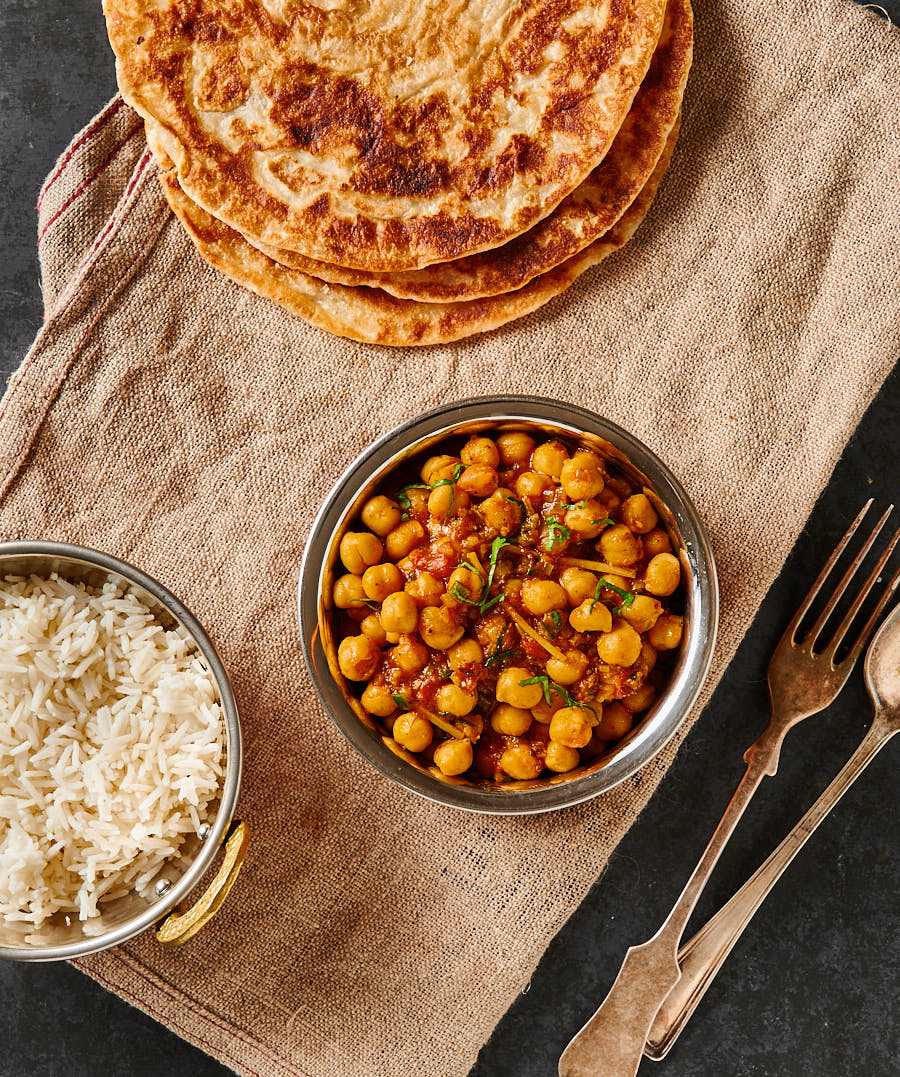 Easy chana masala, rice and parathas table scene from above.