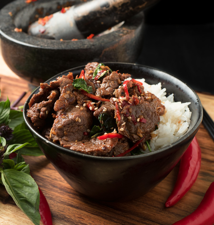Thai basil beef with red chilies and jasmine rice front view.