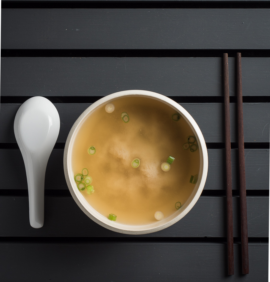 Japanese miso soup in white bowl from above.