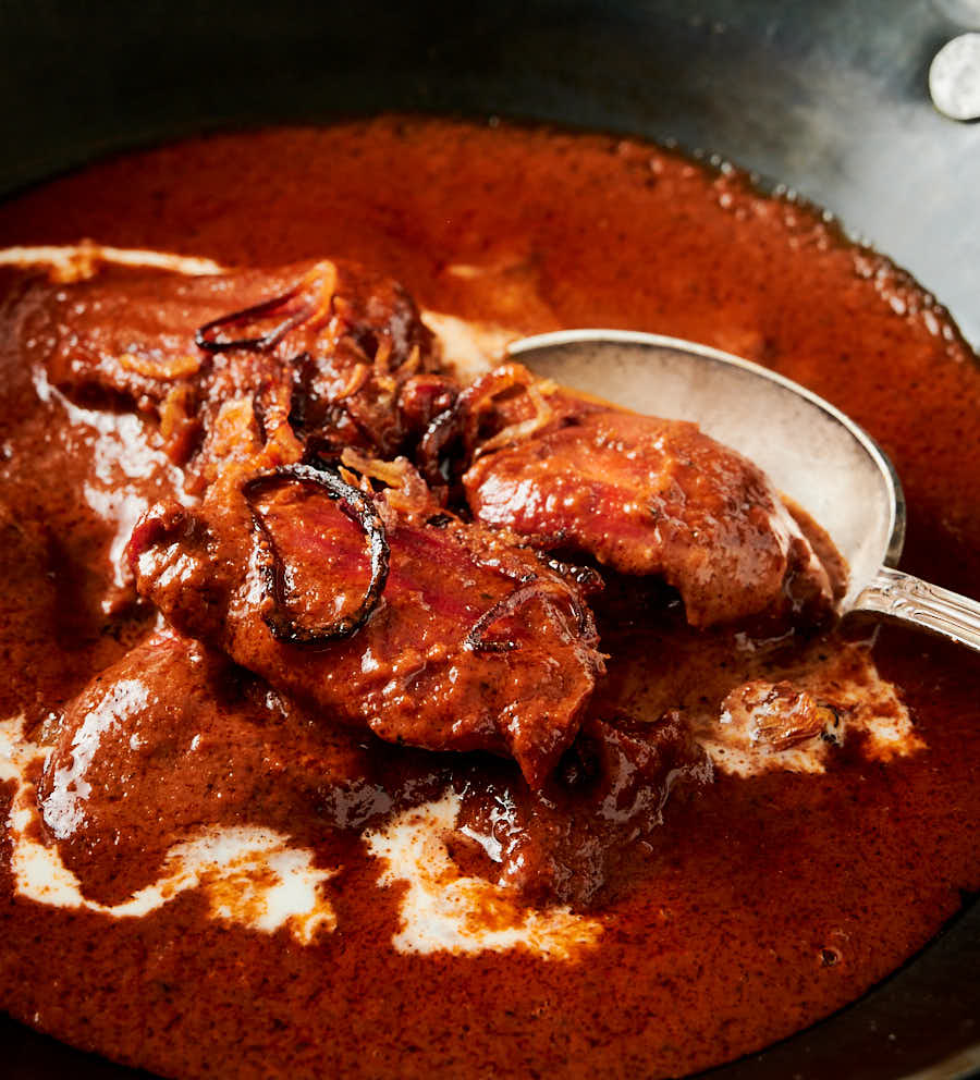 Closeup of a spoonful of chicken tikka masala