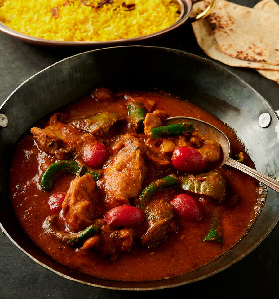Chicken jalfrezi with serving spoon from the front.