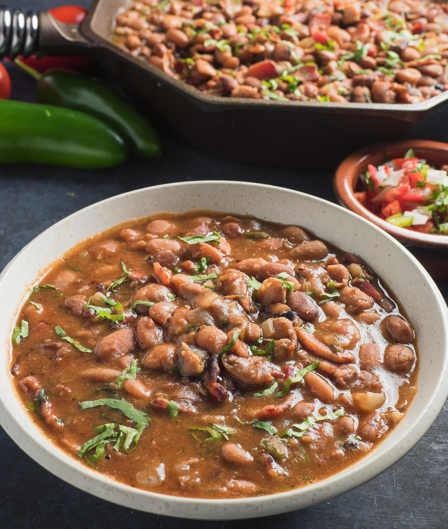 Mexican charro beans in a white bowl.