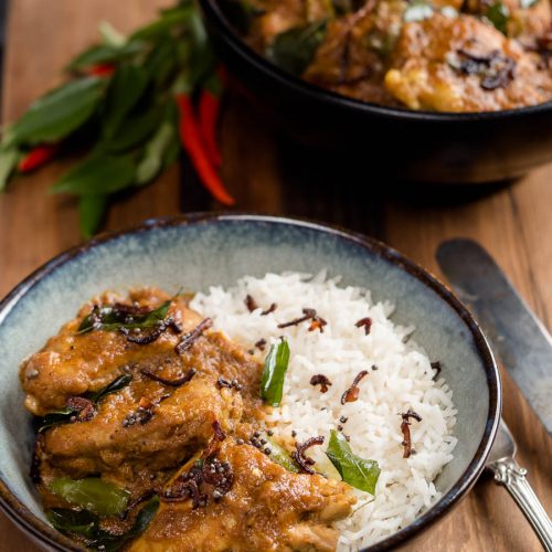 Nadan chicken curry in a bowl with rice.
