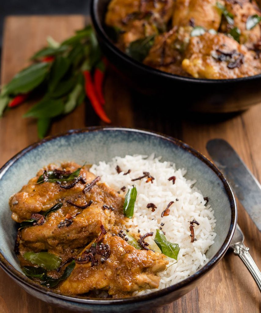 Nadan chicken curry in a bowl with rice.