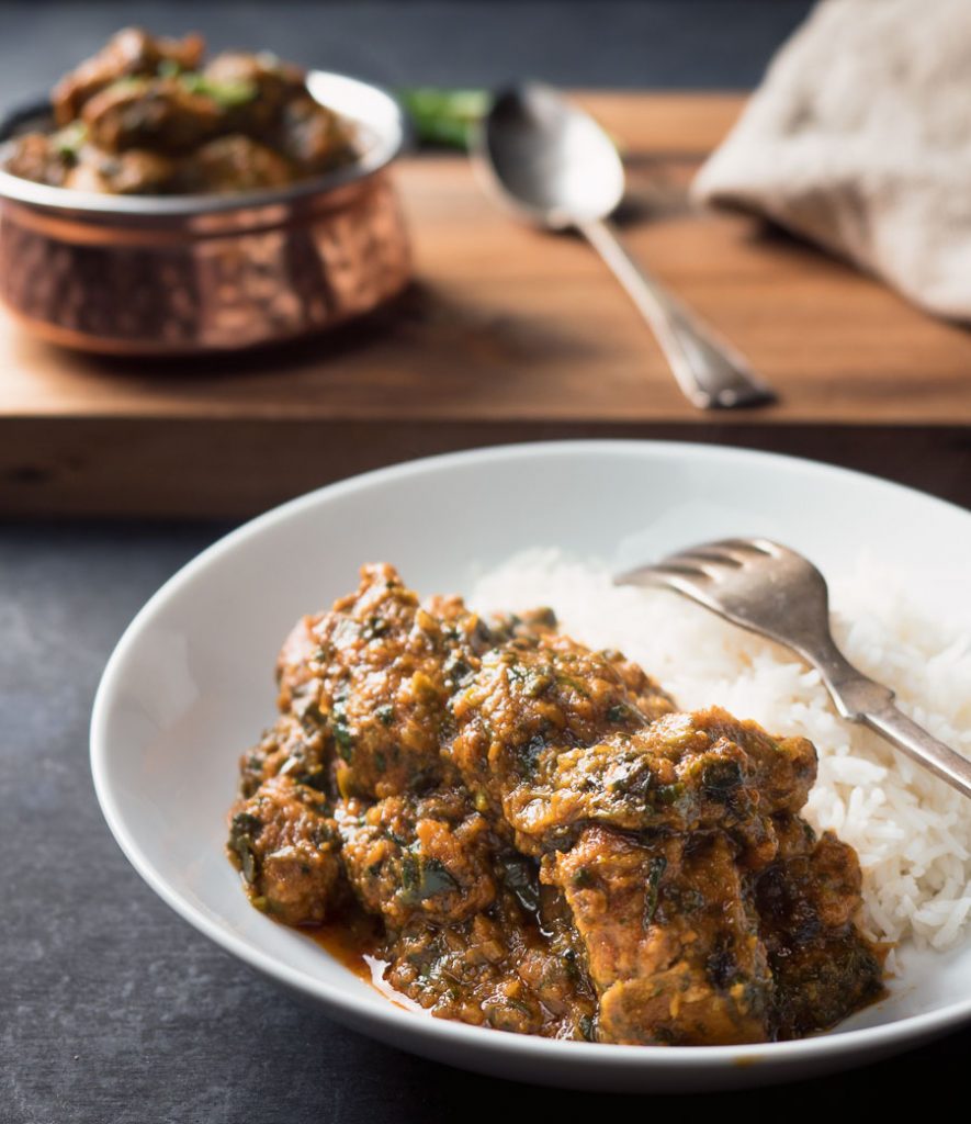 Lamb saag with rice on a plate.