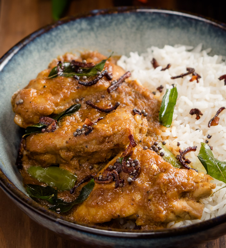 Close-up of nadan chicken curry with rice.