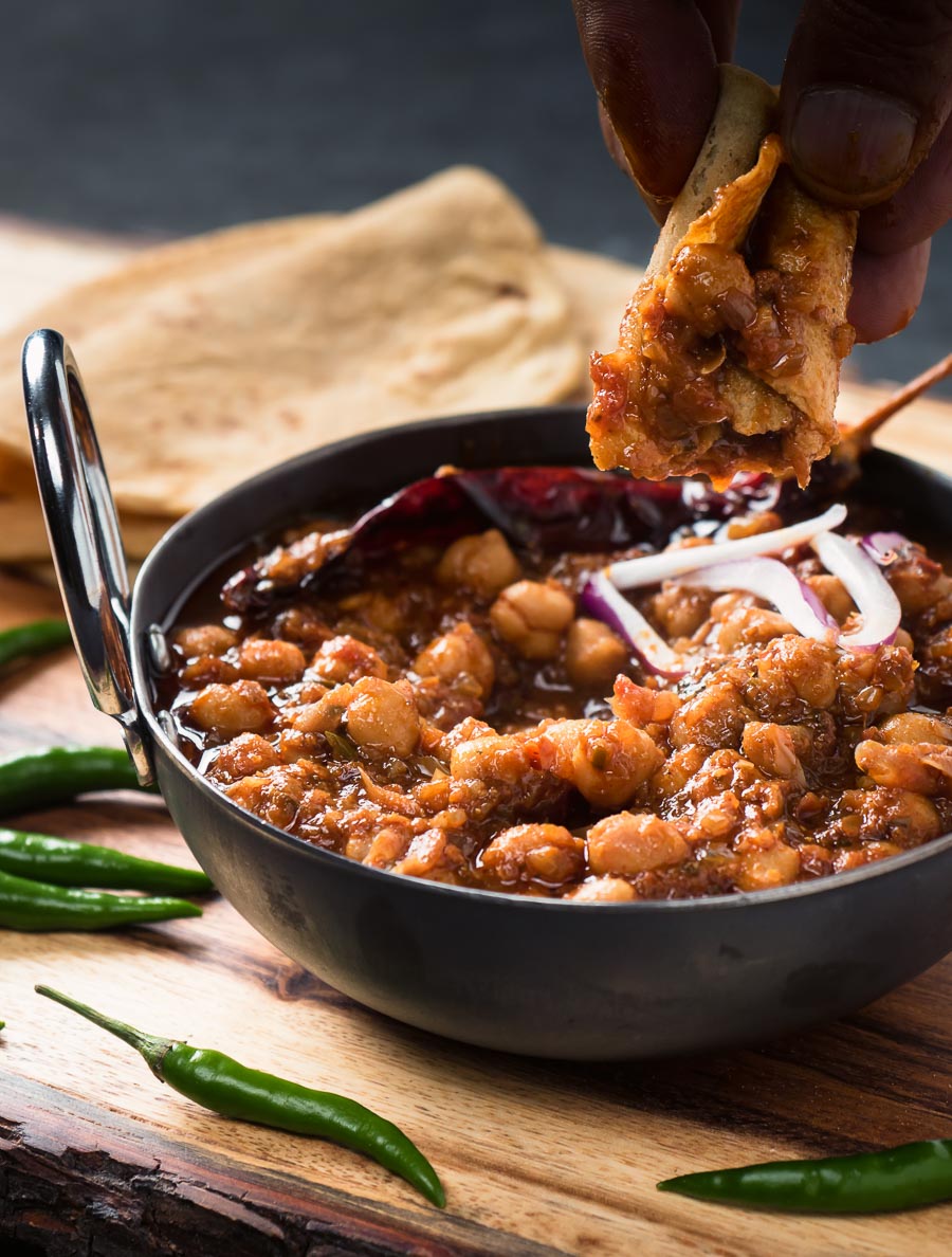 Dipping chapati into Punjabi chole masala