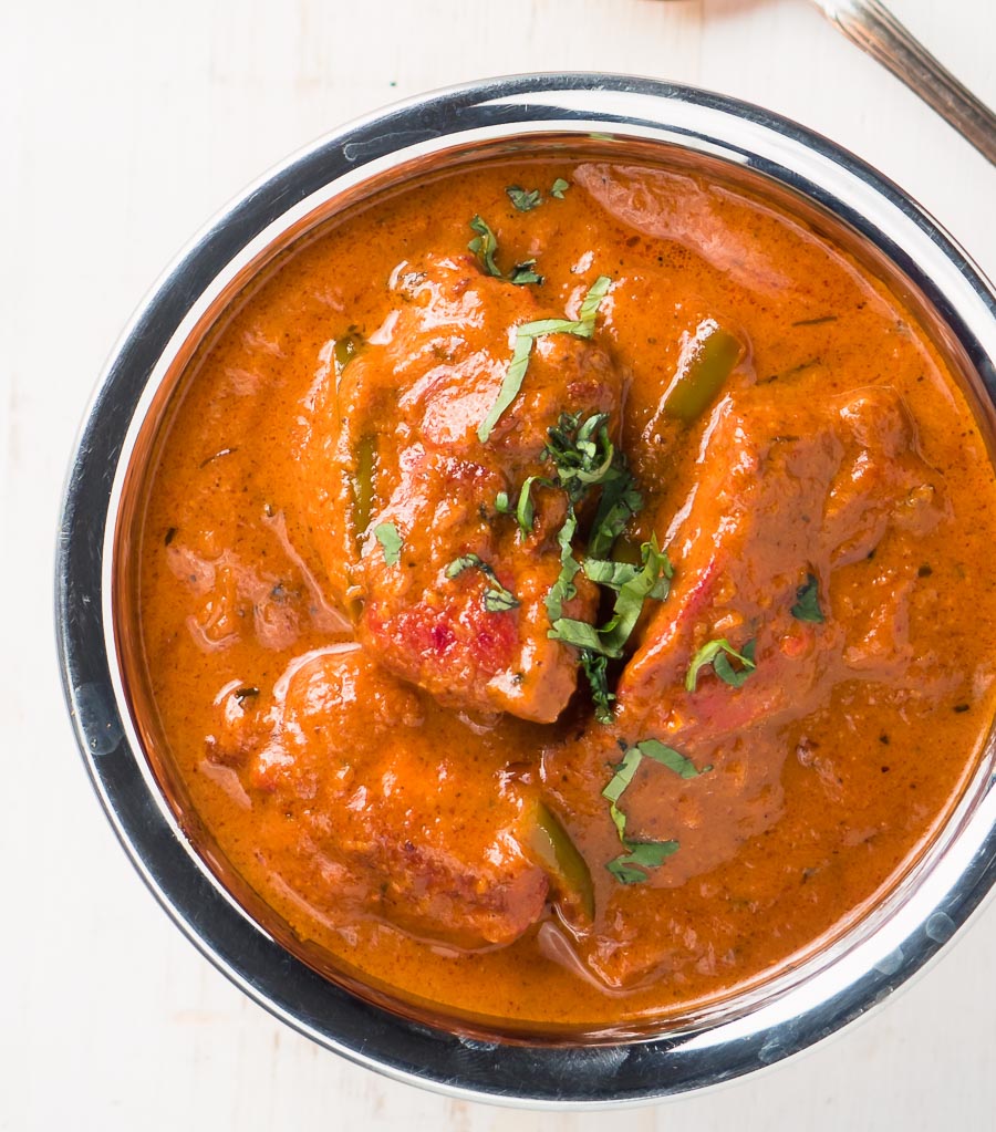 Restaurant butter chicken in a bowl from above - close up.