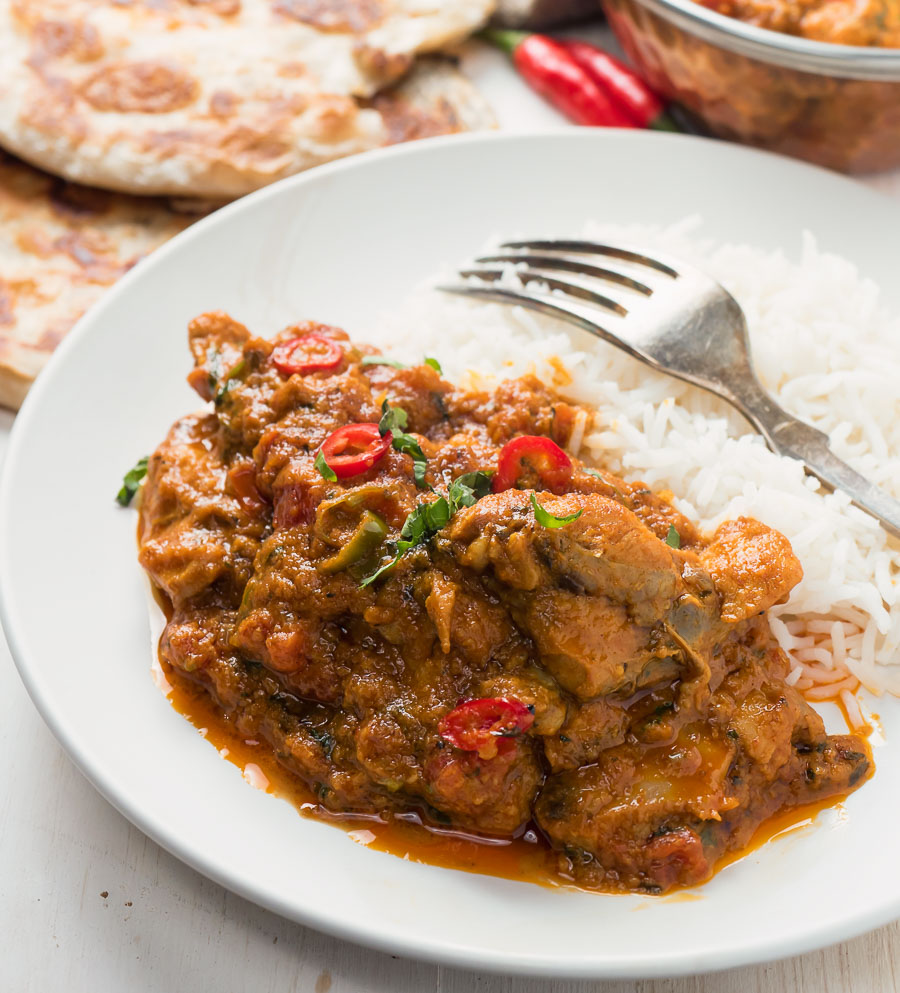 Restaurant karahi chicken on a plate with rice.