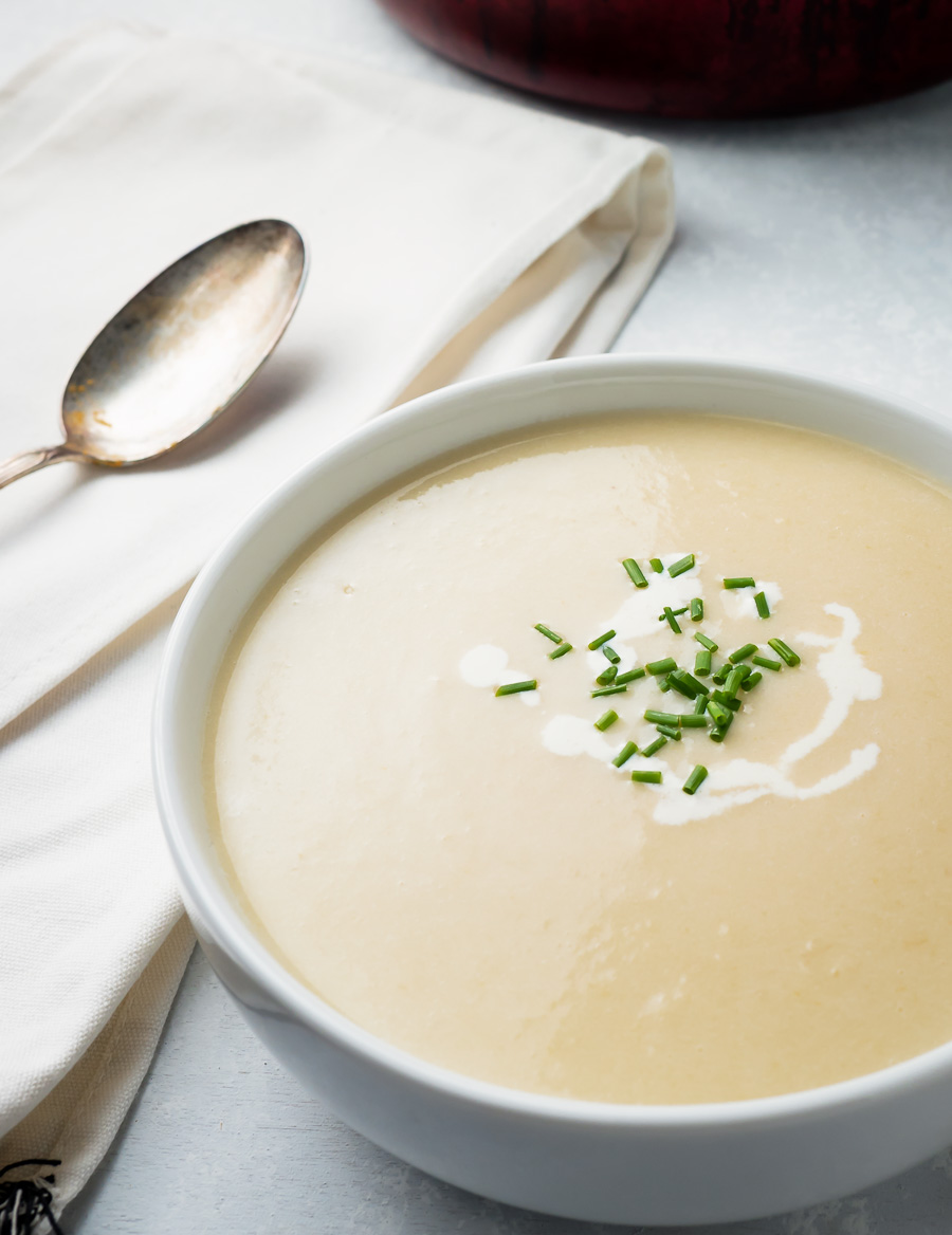 Potato leek soup in a white bowl.