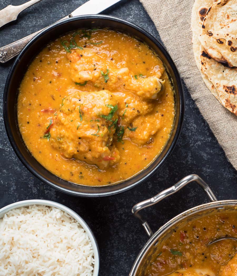 Chicken dhansak in a black bowl from above - close up.