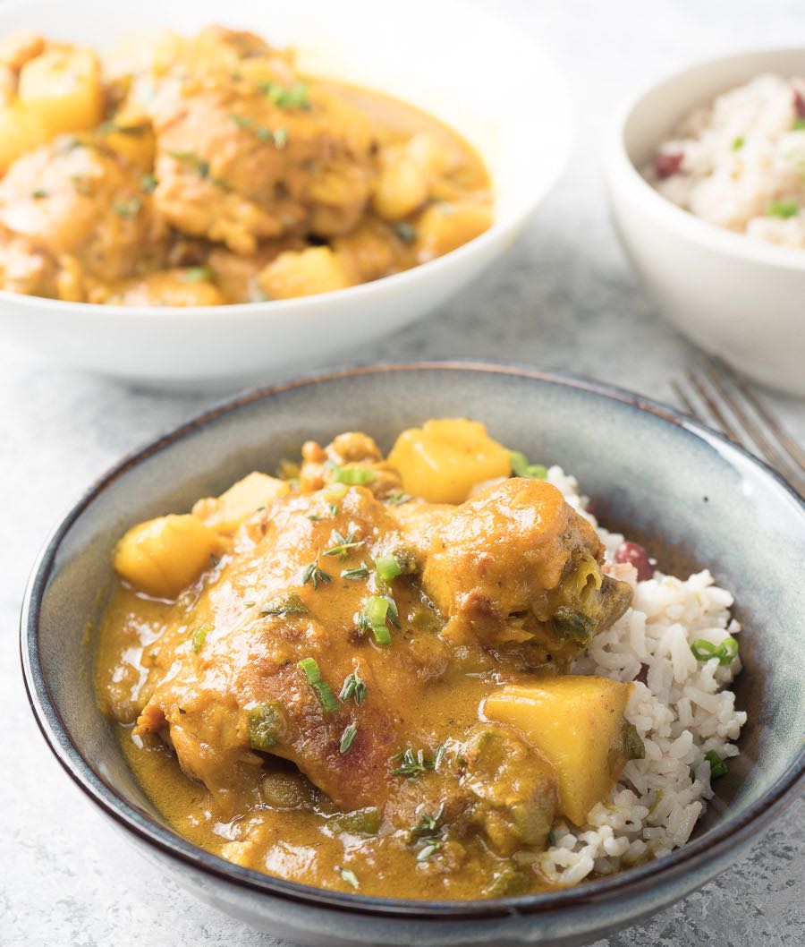 Jamaican curry chicken served with rice and peas.