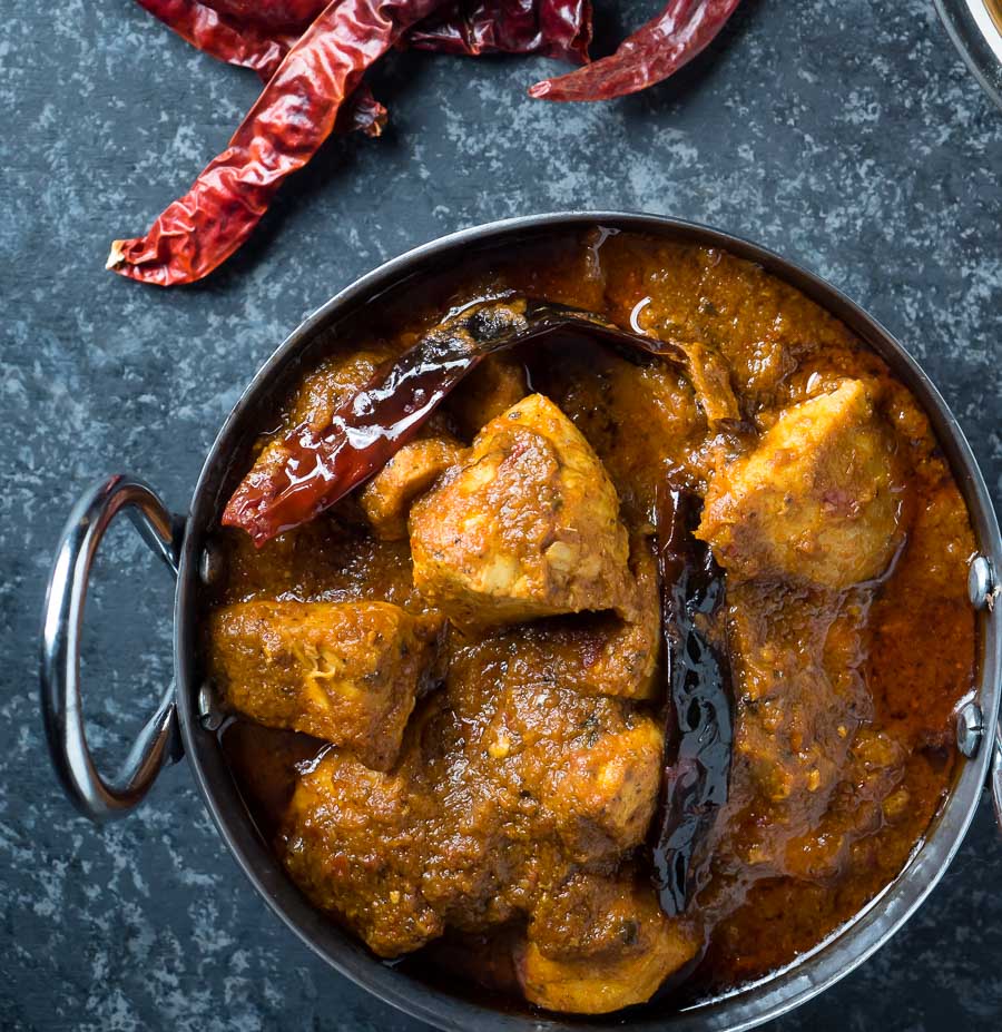 Chicken vindaloo in a metal bowl from above.