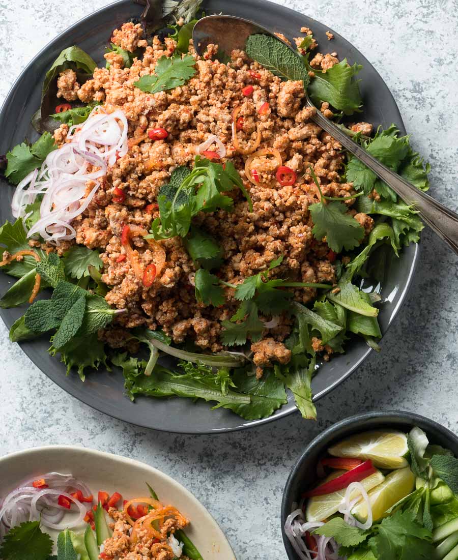 Thai larb salad with greens on a plate from above.