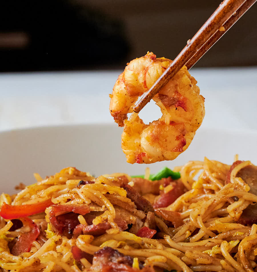 Shrimp held in chopsticks from the front.