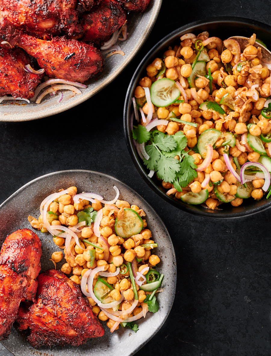 Plate with chana chaat with tandoori chicken from above.