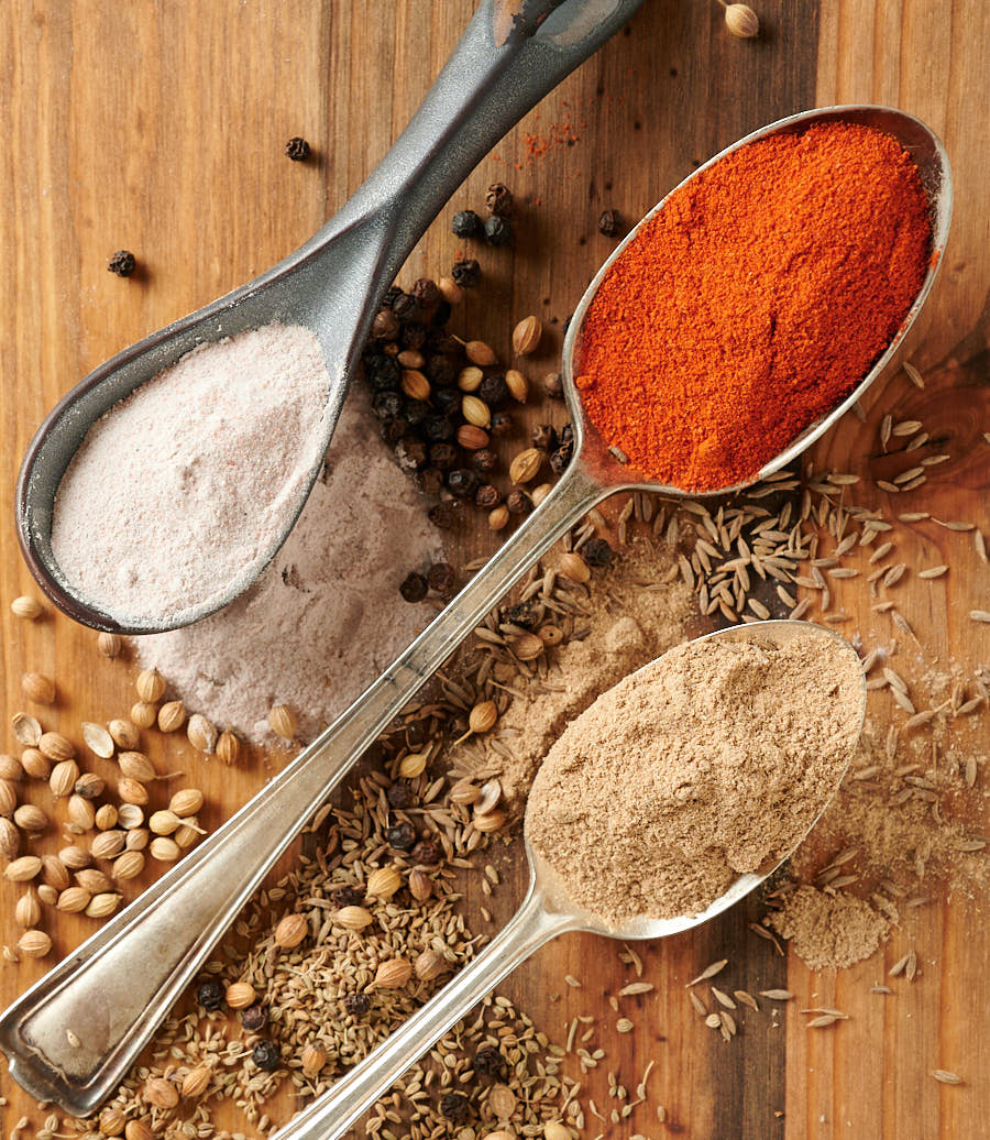 Chaat masala ingredients. Spices on spoons.