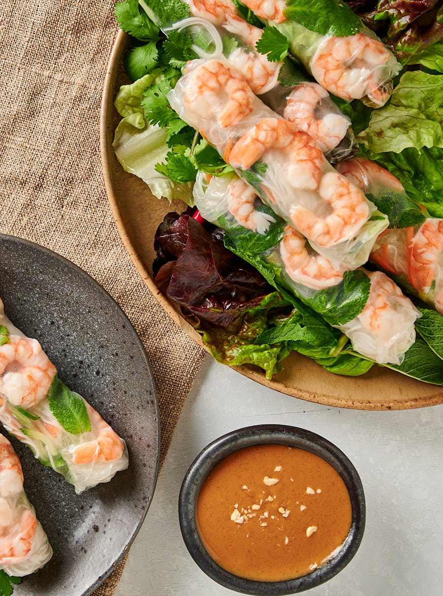 Overhead view of Vietnamese spring rolls on a platter and plate.