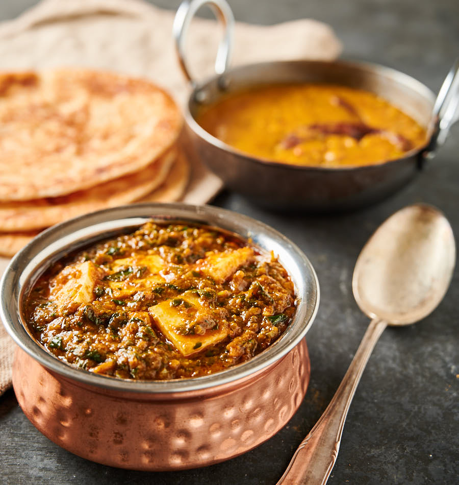 Palak paneer, dal and parathas from the front.