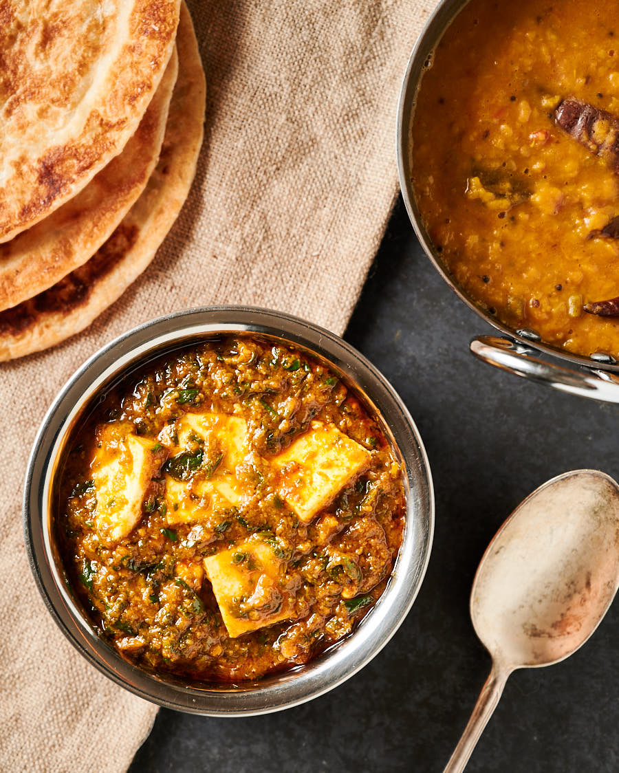 Table scene with dal and parathas from above.