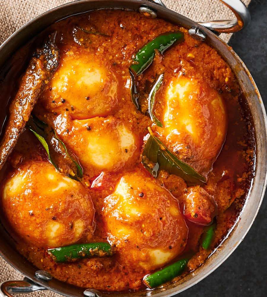 Close-up of egg curry in a bowl from above.