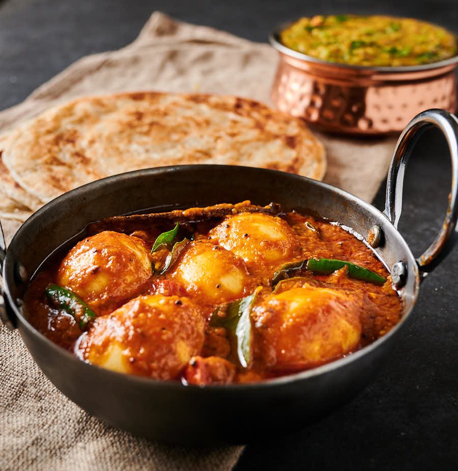 South Indian egg curry table scene from the front.