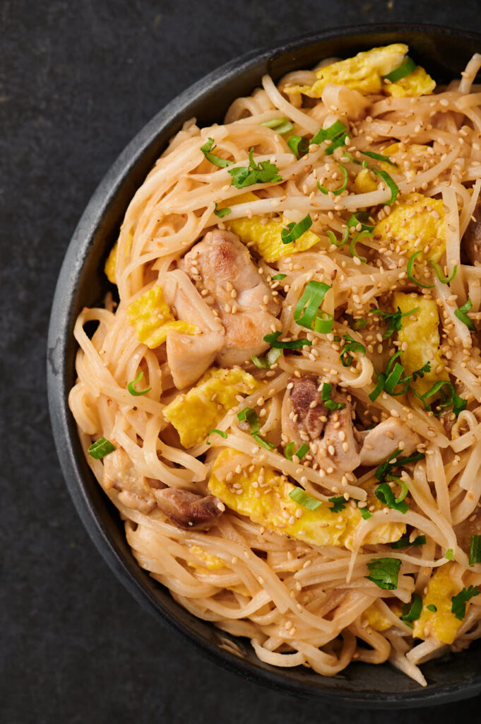 Close up of Thai sesame noodles on an Asian plate from above.