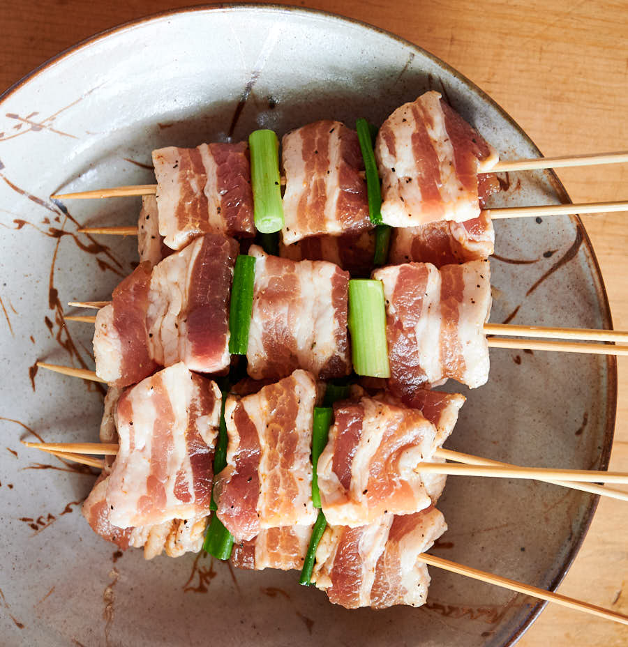 Uncooked pork belly skewers ready to go on the grill.