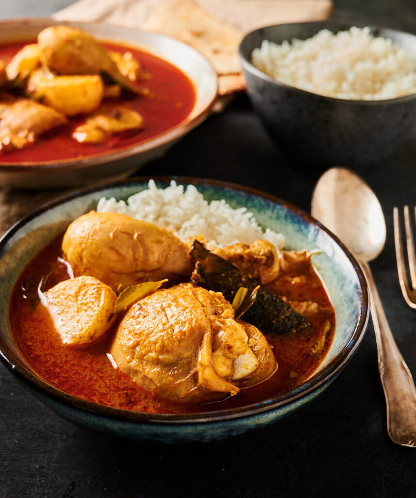 Kari Ayam and rice in a bowl from the front