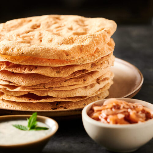 Tall stack of papadum from the front.