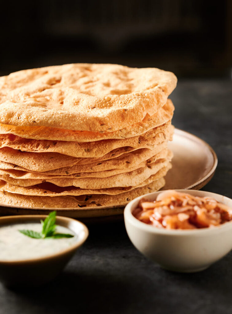 Tall stack of papadum from the front.