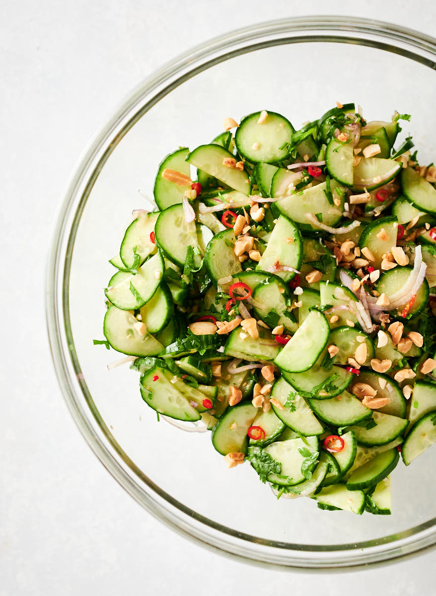 Thai cucumber salad in a large clear serving bowl from above.