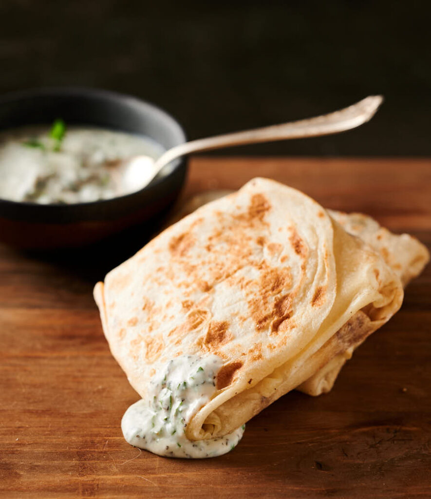 Mutton roti drizzled with mint raita.