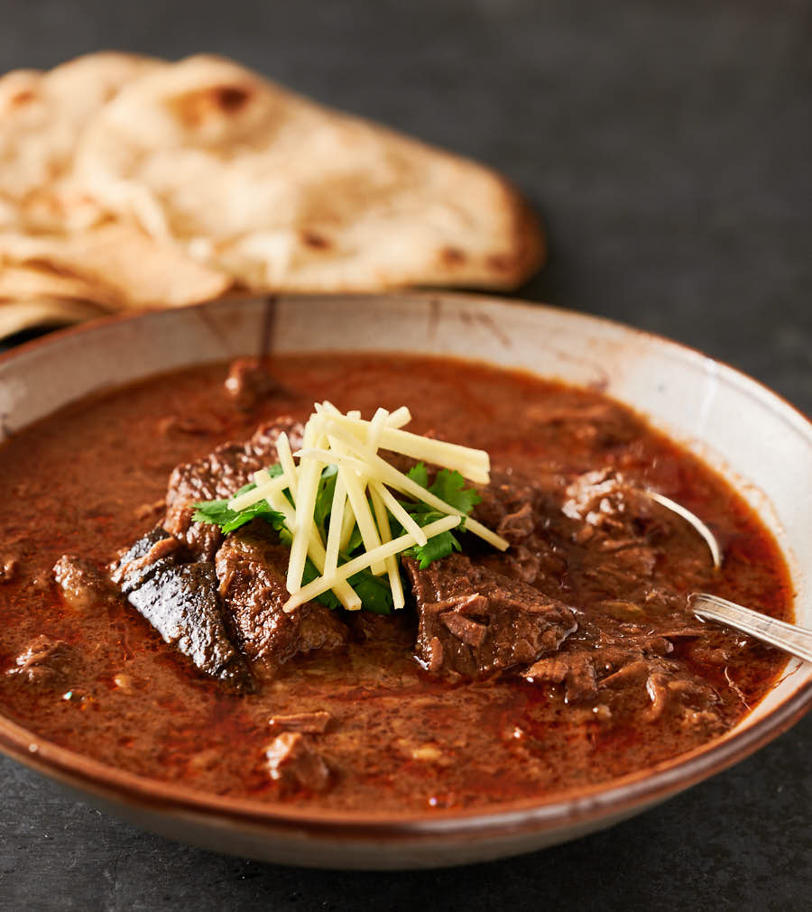 Bowl of nihari gosht with spoon ready to eat. 