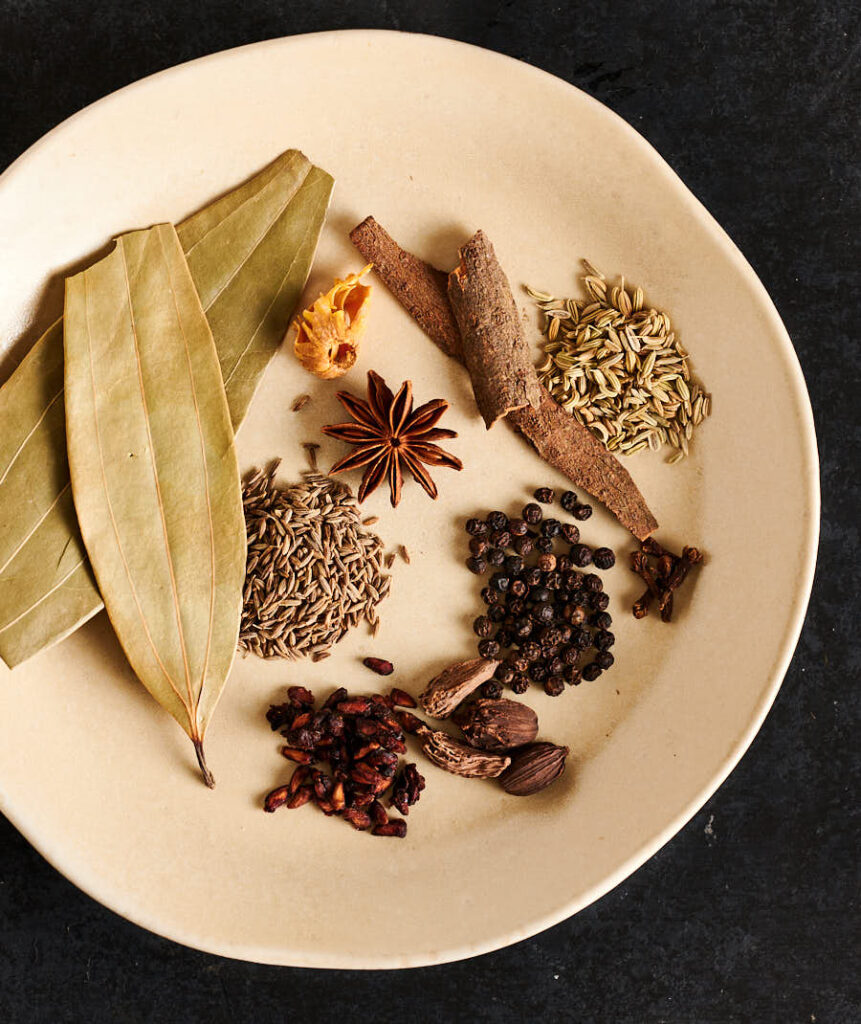 Whole spices for nihari masala on a plate from above.